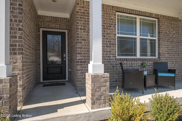 entrance to property featuring brick siding