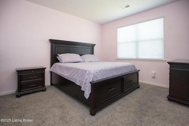bedroom with light carpet, visible vents, and baseboards