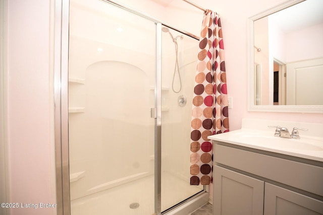bathroom with a stall shower and vanity