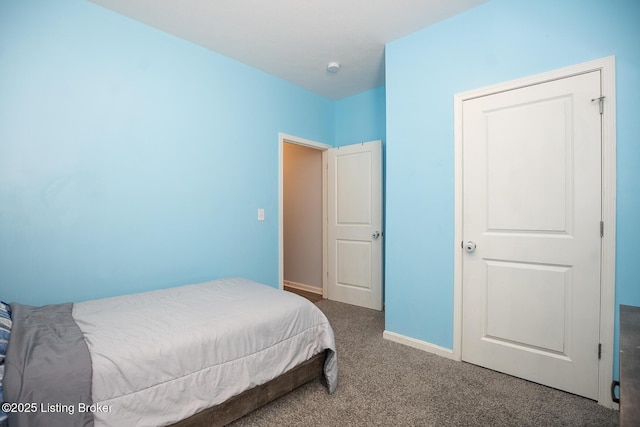 carpeted bedroom featuring baseboards