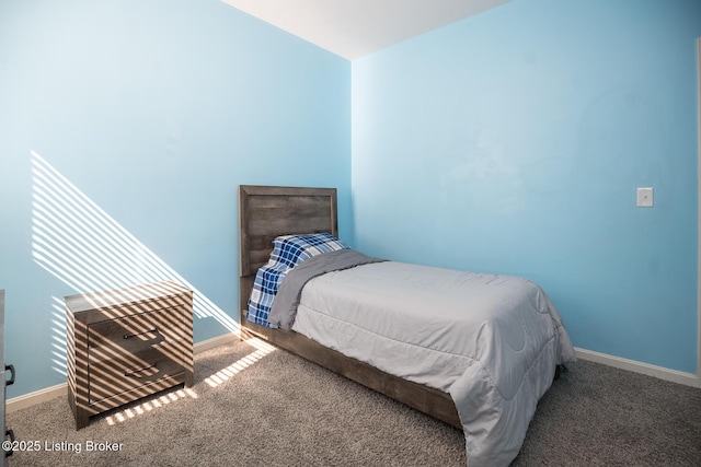 carpeted bedroom featuring baseboards