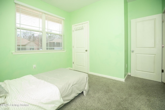 carpeted bedroom featuring baseboards