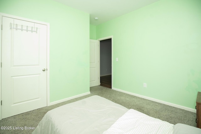 bedroom featuring carpet and baseboards