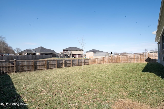 view of yard with a fenced backyard