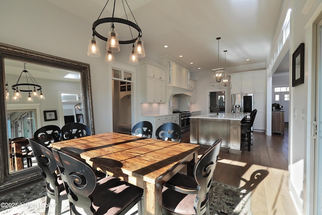 dining room with recessed lighting and wood finished floors