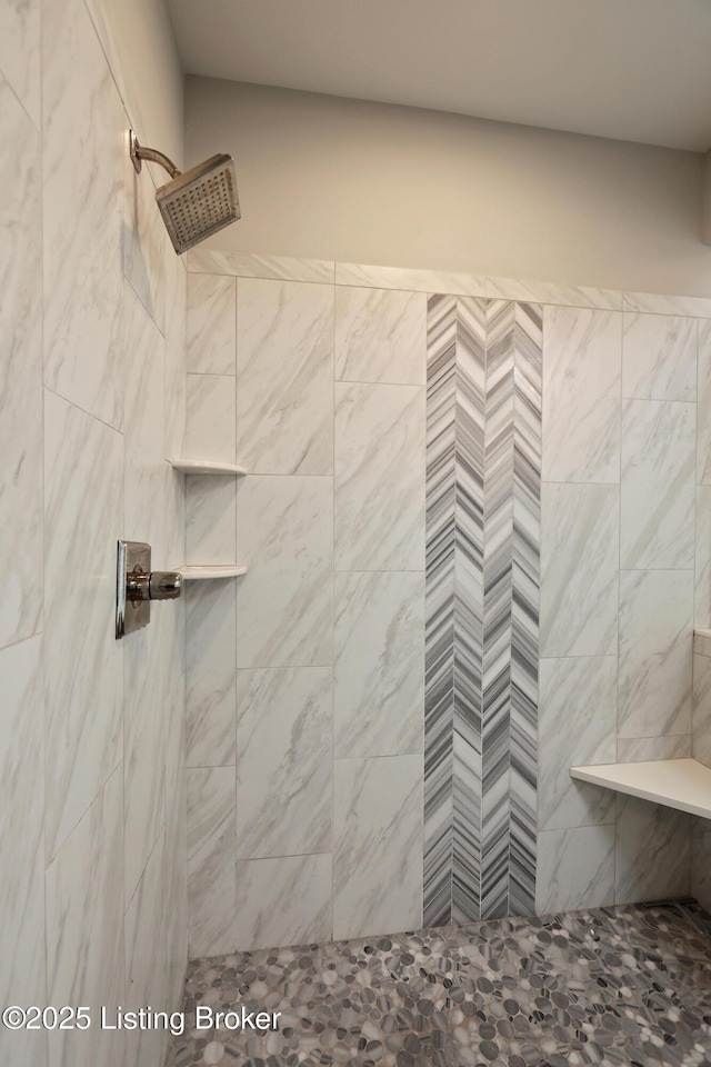 full bath featuring a tile shower