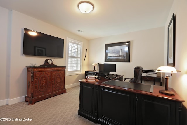 office space with visible vents, light carpet, and baseboards