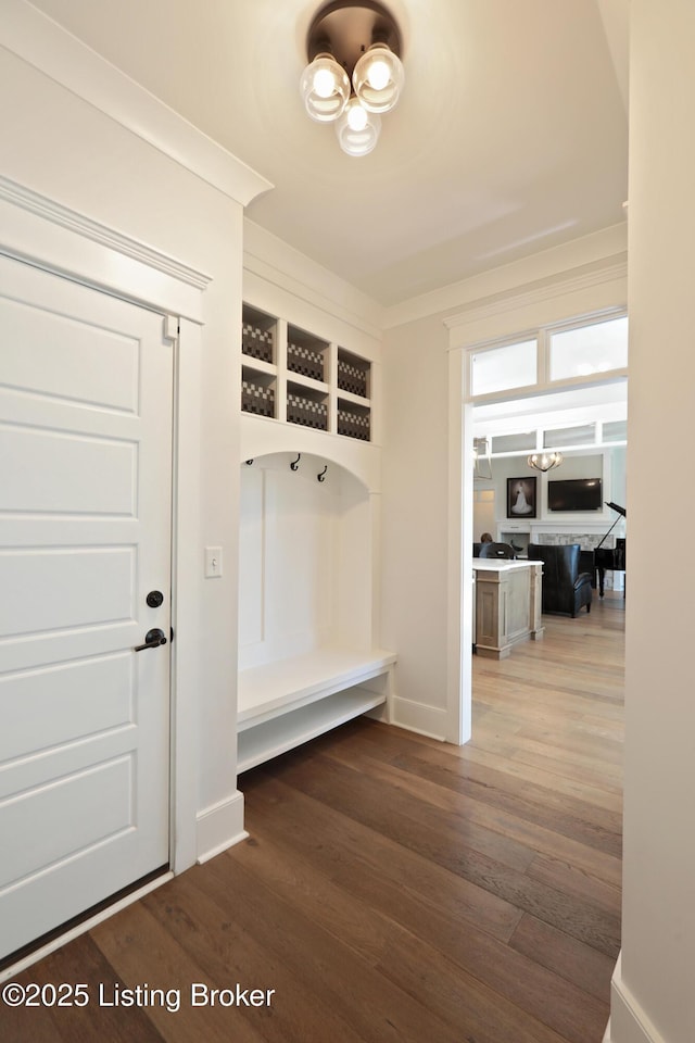 mudroom featuring baseboards and wood finished floors