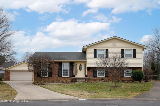 split level home featuring a garage, brick siding, and a front lawn