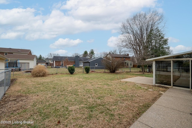 view of yard with a residential view, a fenced backyard, and a patio