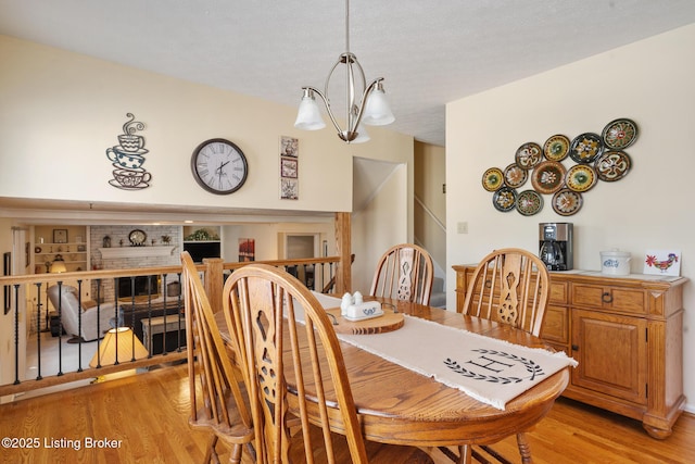 dining space with light wood finished floors and a notable chandelier