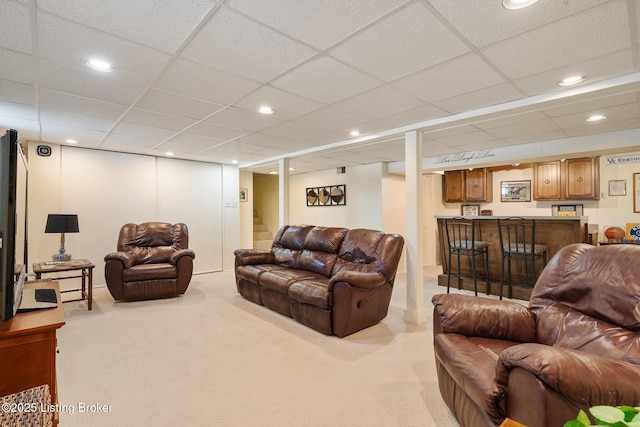 carpeted living area featuring recessed lighting, bar area, a drop ceiling, and stairs