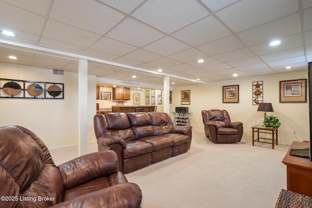 carpeted living area featuring visible vents, a drop ceiling, and recessed lighting