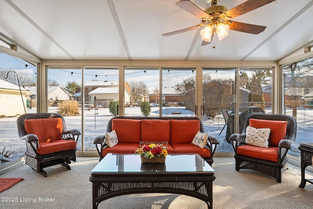 sunroom / solarium with lofted ceiling and ceiling fan