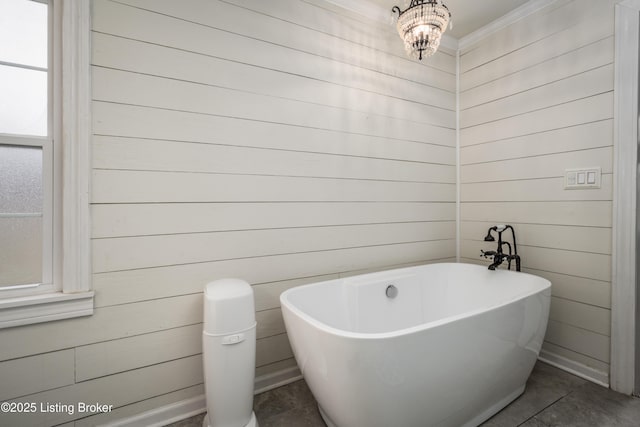 bathroom featuring a soaking tub and ornamental molding