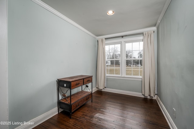 empty room with crown molding, baseboards, and dark wood-type flooring