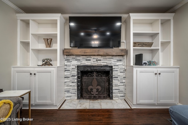 living room featuring ornamental molding, wood finished floors, and a tile fireplace