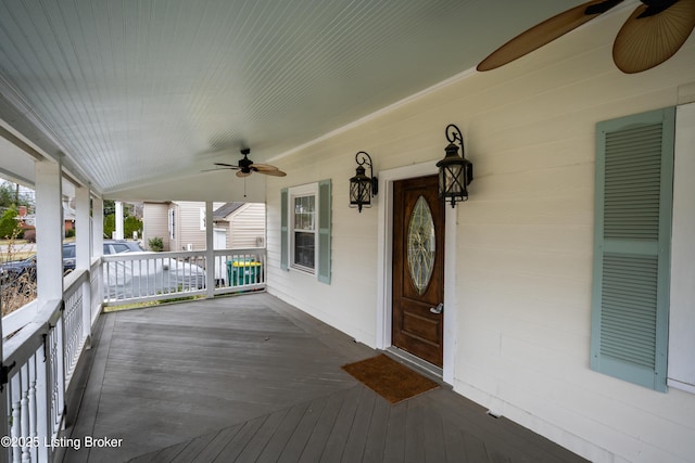 wooden terrace with a porch and a ceiling fan