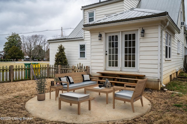 back of property featuring metal roof, a patio, fence, and entry steps