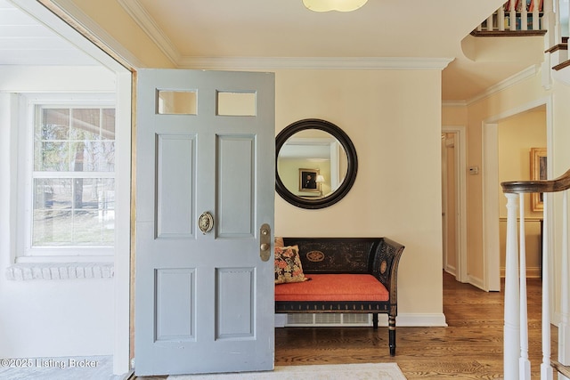 foyer entrance with stairway, ornamental molding, baseboards, and wood finished floors