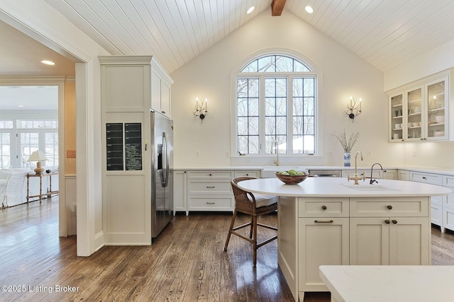 kitchen with dark wood finished floors, stainless steel fridge, and a sink