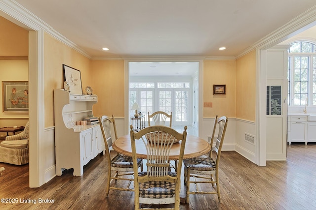 dining area featuring recessed lighting, wood finished floors, and ornamental molding