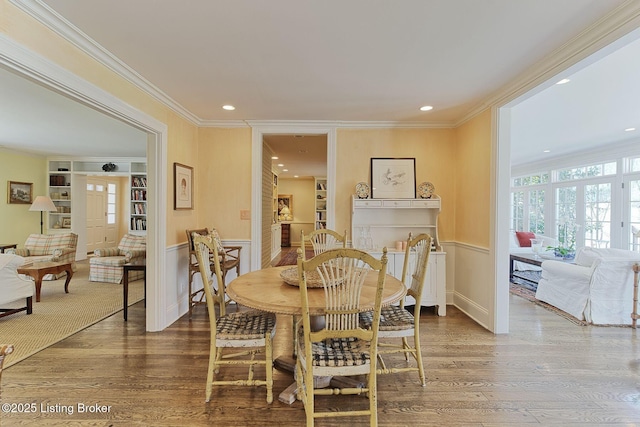 dining space with recessed lighting, ornamental molding, baseboards, and wood finished floors