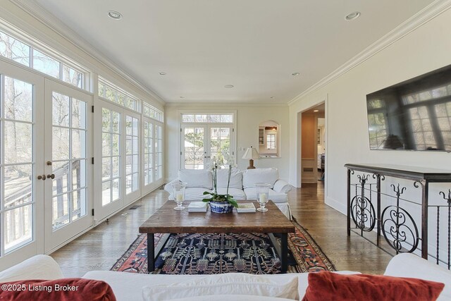 living area with recessed lighting, french doors, wood finished floors, and ornamental molding