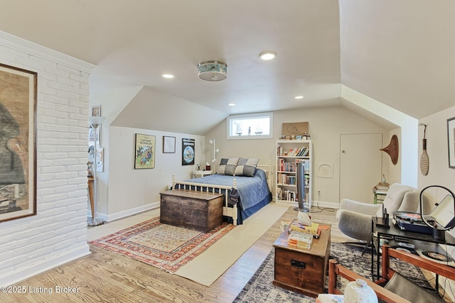 bedroom with recessed lighting, baseboards, lofted ceiling, and wood finished floors