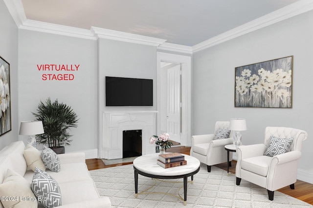 living room featuring light wood finished floors, a fireplace with flush hearth, ornamental molding, and baseboards