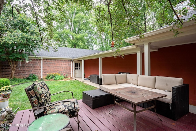 wooden terrace featuring a lawn, outdoor dining area, and an outdoor living space