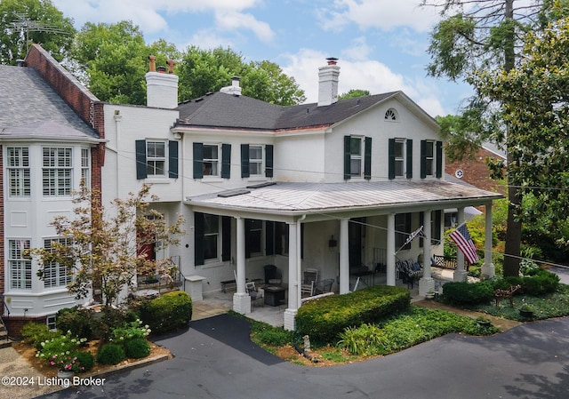 view of front of house featuring a porch and brick siding