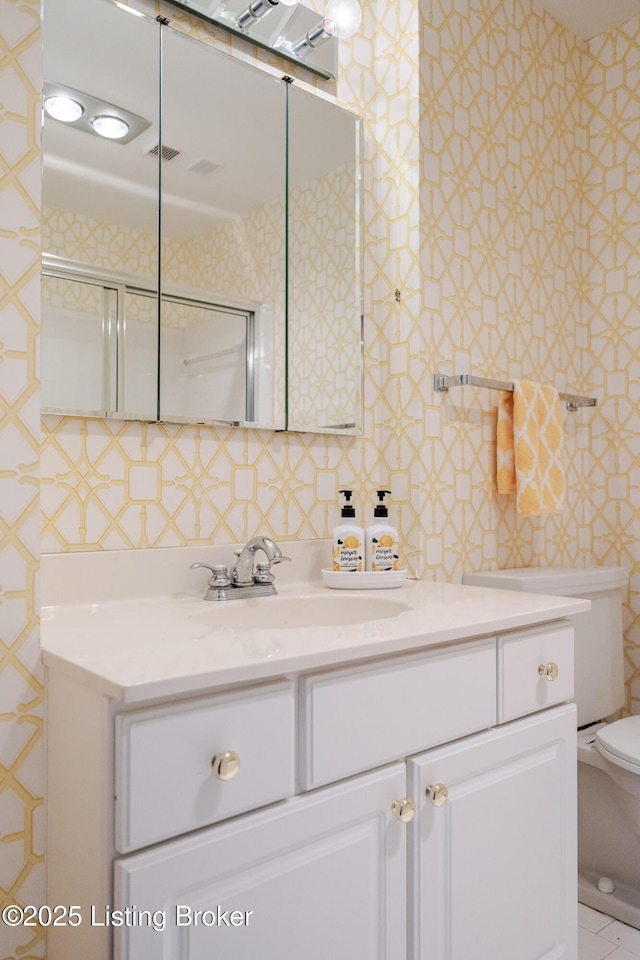 bathroom featuring toilet and vanity