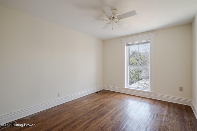 spare room featuring a ceiling fan, baseboards, and wood finished floors