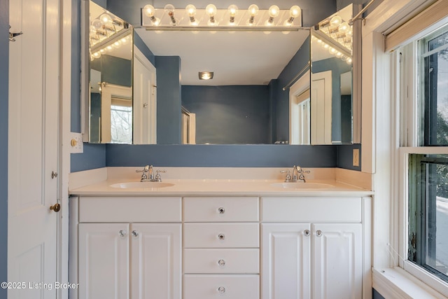 full bathroom with a sink and double vanity