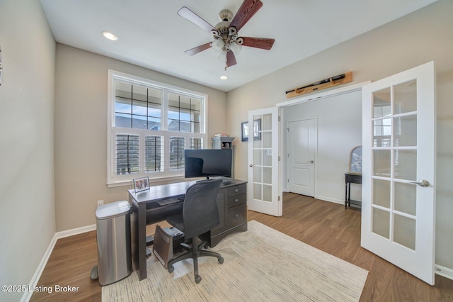 office area with ceiling fan, baseboards, wood finished floors, and french doors