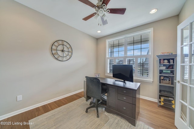 home office with light wood finished floors, recessed lighting, a ceiling fan, and baseboards