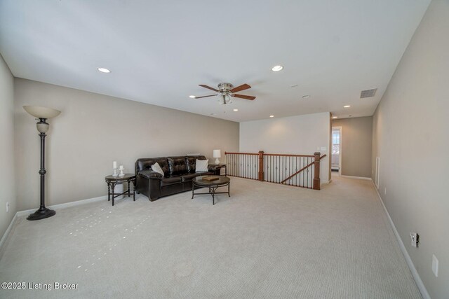 living area with carpet floors, visible vents, and recessed lighting