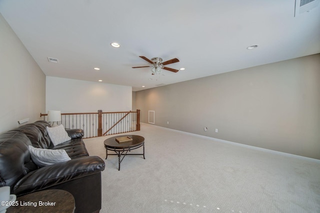 living area featuring recessed lighting, light carpet, an upstairs landing, baseboards, and visible vents