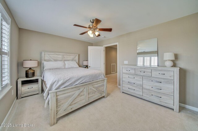 bedroom with light carpet, ceiling fan, and baseboards