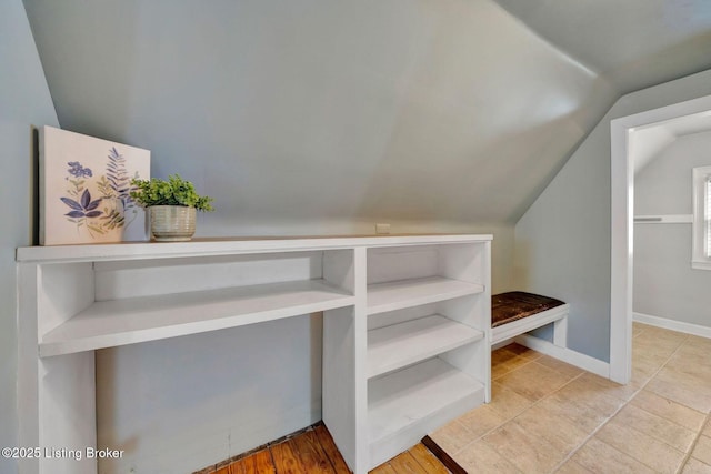 walk in closet with vaulted ceiling