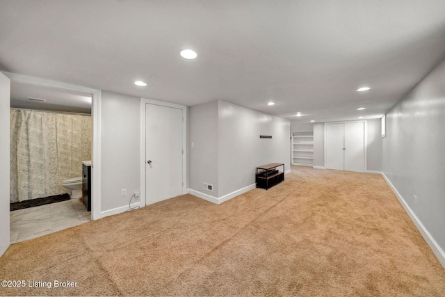 finished basement with baseboards, tile patterned flooring, carpet flooring, and recessed lighting