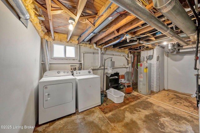 clothes washing area featuring washing machine and dryer, laundry area, and water heater