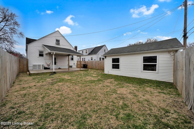 rear view of property with a patio area, a fenced backyard, and a lawn