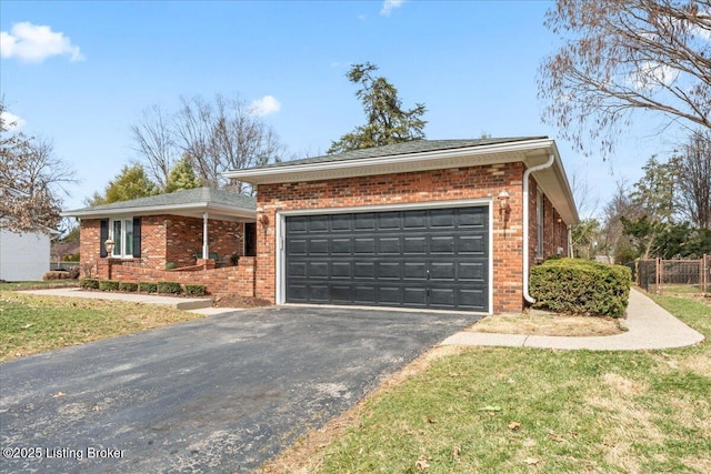 single story home with driveway, an attached garage, fence, and brick siding