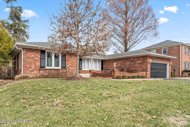 view of front of home with a garage, brick siding, driveway, and a front lawn