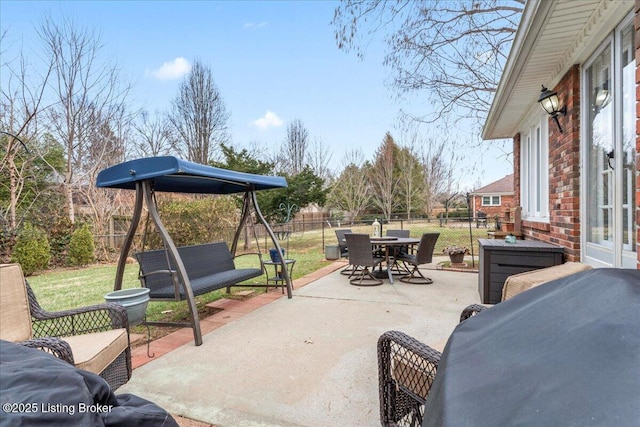 view of patio featuring a fenced backyard and outdoor dining area