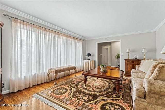 living room featuring ornamental molding and wood finished floors