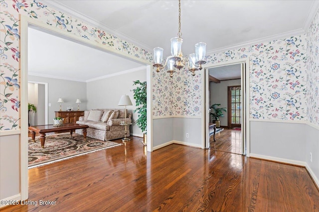 interior space featuring a wainscoted wall, crown molding, and wallpapered walls