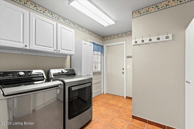 washroom with light tile patterned flooring, cabinet space, and washer and dryer